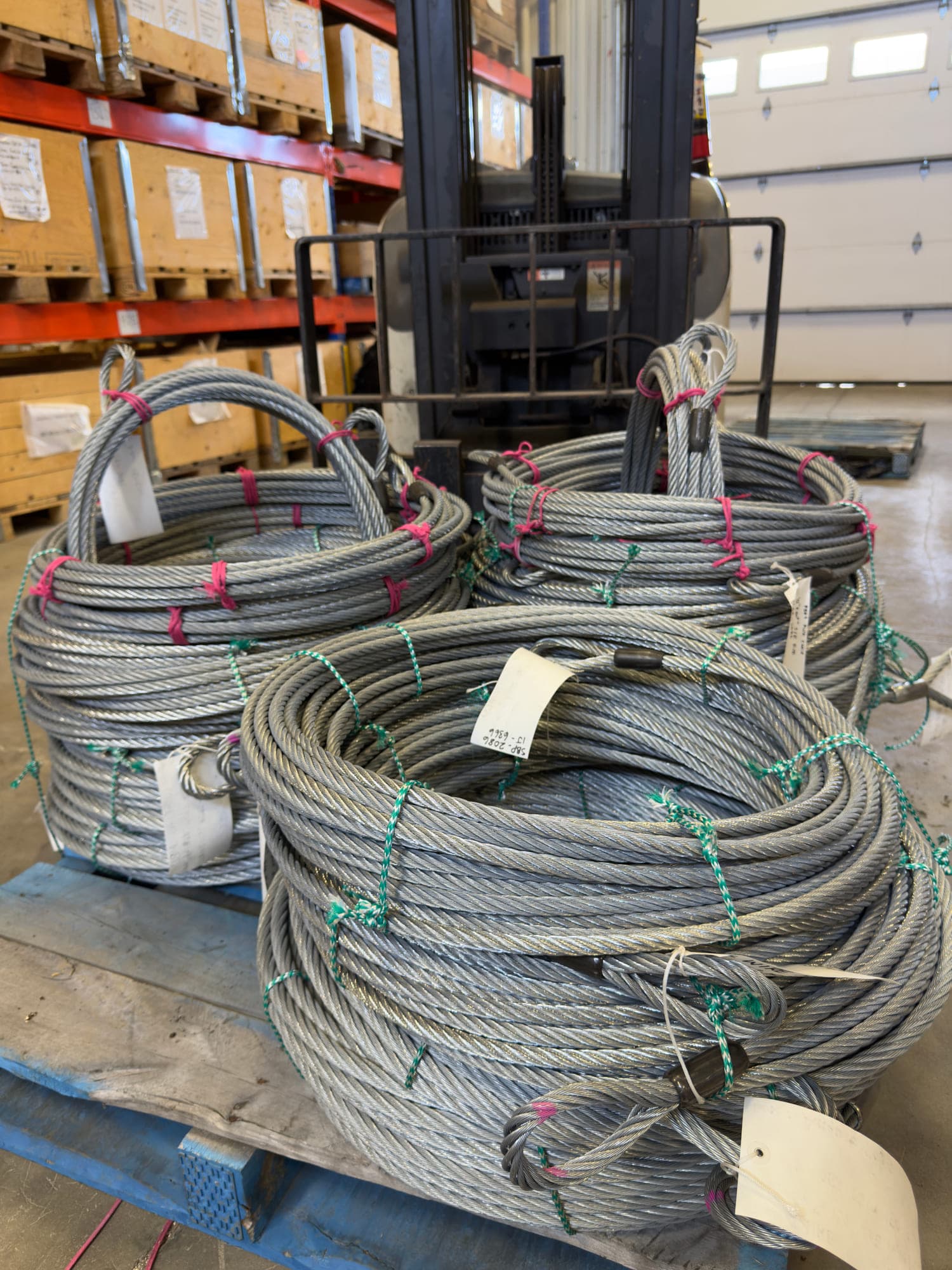 Finished wire rope assemblies coiled, whipped and tagged on the pallet.